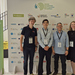 Drei Männer und eine Frau stehen vor einer Stellwand mit den Logos der Beteiligten der Energiewendekonferenz