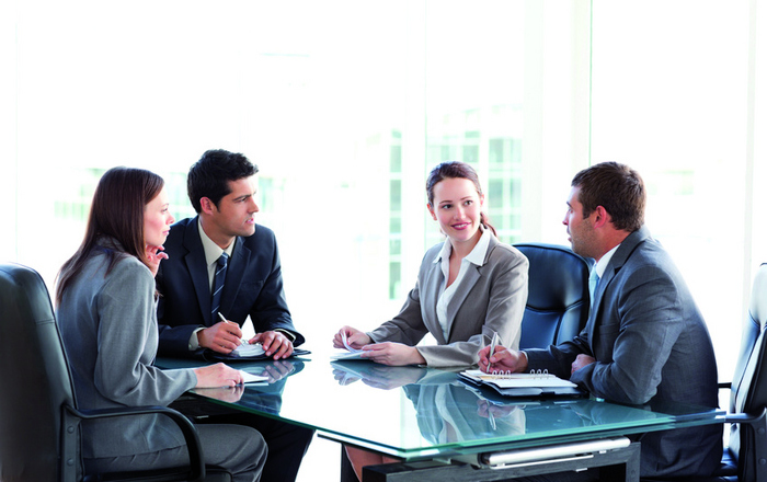 Menschen sitzen um einen Tisch