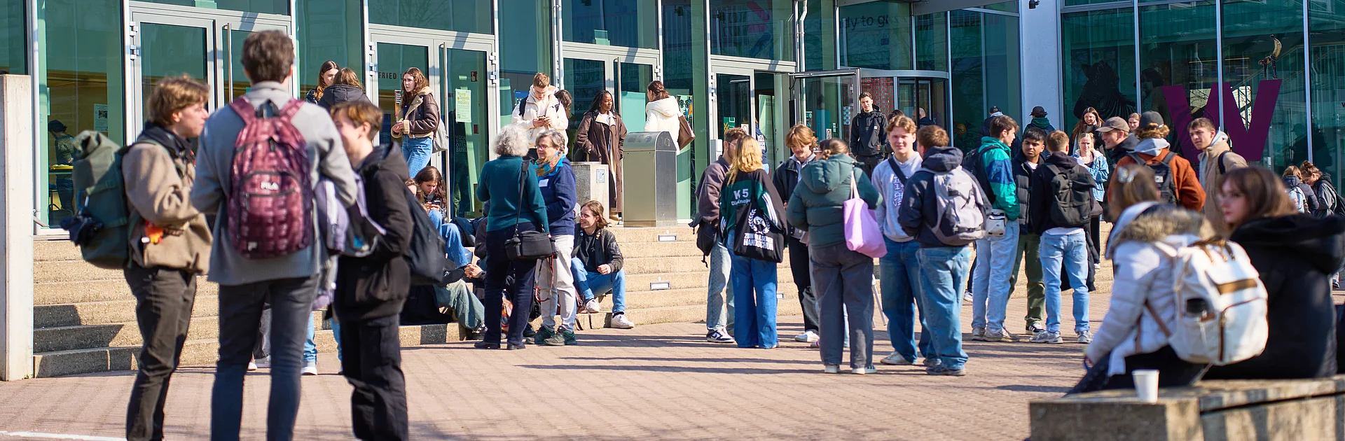 Studierende stehen draußen vor dem Gebäude D