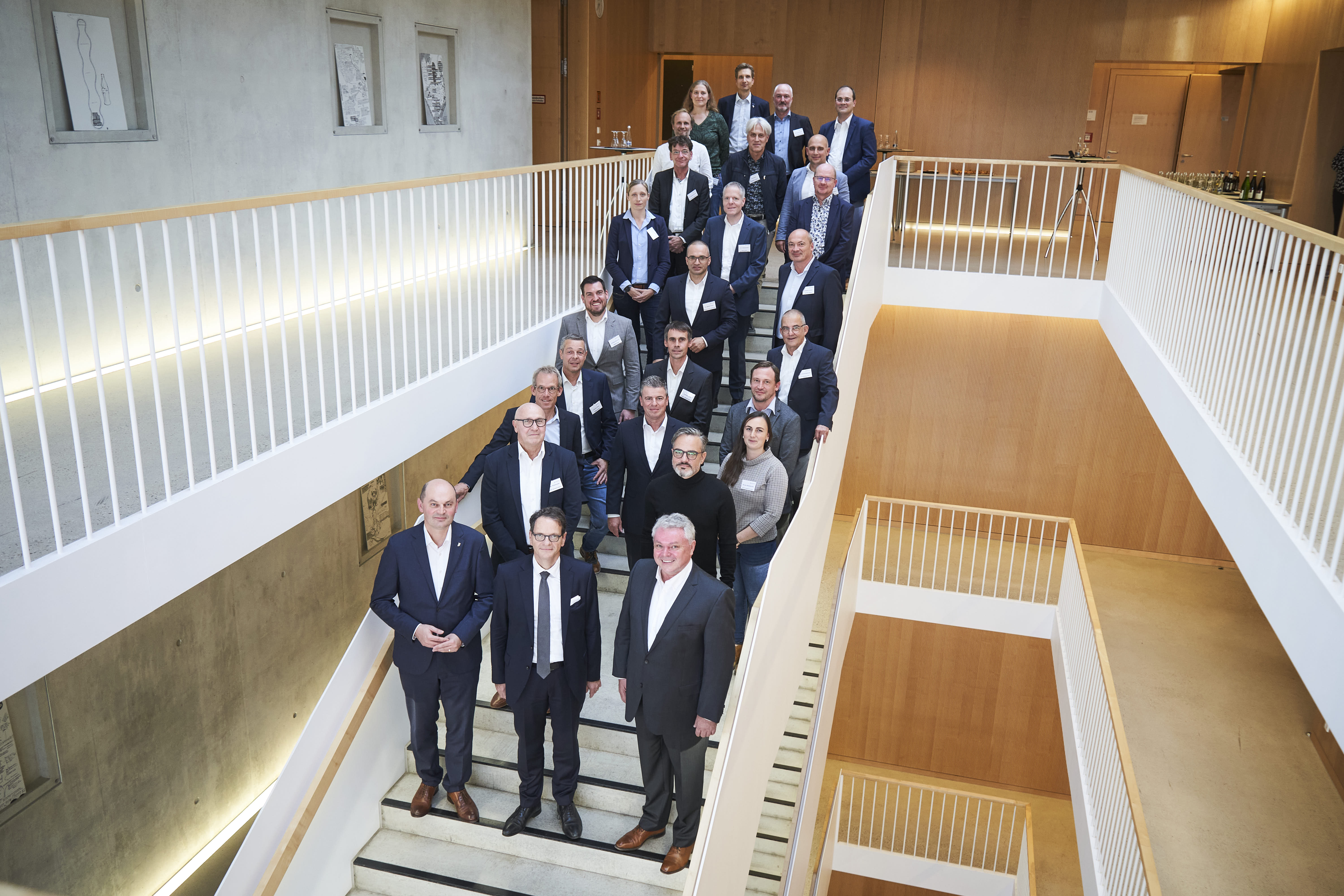 Gruppenbild mit den Beteiligten auf der Treppe im E-Gebäude